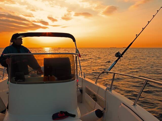 Angler on a fishing boat in the bay at Islands of Rockport