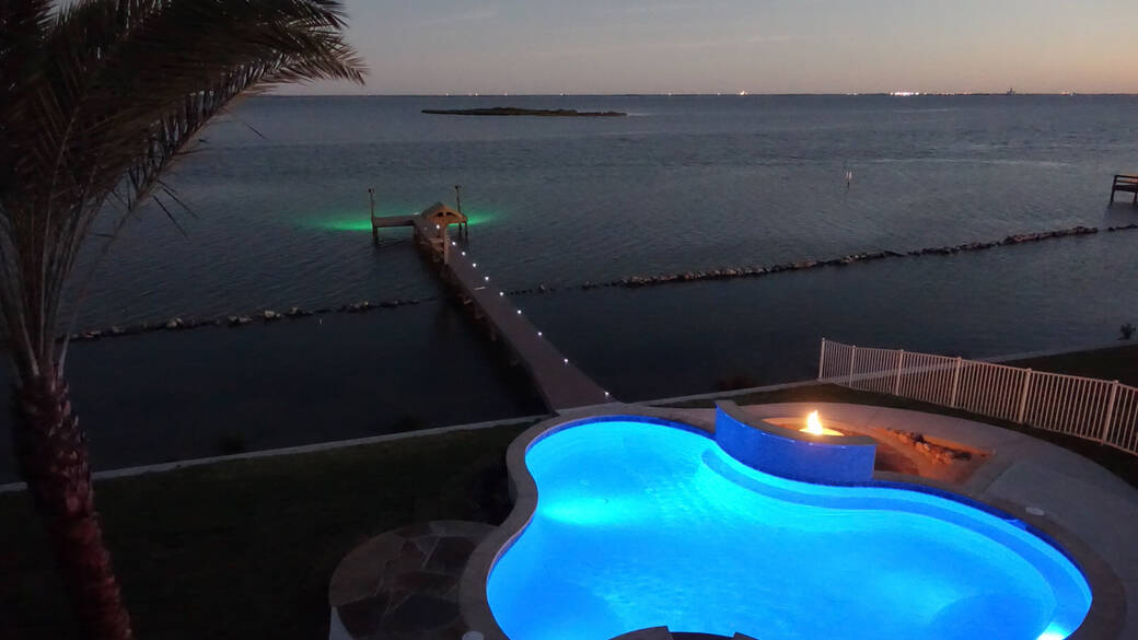 Dock and pool lit up at night at Islands of Rockport